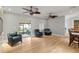 Spacious living room with hardwood floors, ceiling fans, and view to covered patio at 493 Lucerne Ave, Tampa, FL 33606