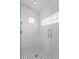 Glass enclosed shower featuring white subway tile, built in shower seat and contrasting black and white tile floor at 493 Lucerne Ave, Tampa, FL 33606