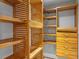 Spacious walk-in closet with custom wood shelving and storage drawers, offering ample organizational options at 493 Lucerne Ave, Tampa, FL 33606