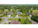 Aerial street view of house featuring mature trees, a well manicured lawn and landscaping at 5182 Championship Cup Ln, Spring Hill, FL 34609