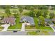 Expansive aerial view showcases the home's layout with a well-kept lawn, mature trees, and surrounding neighborhood at 5182 Championship Cup Ln, Spring Hill, FL 34609