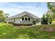 Grassy backyard view highlighting arched windows and a screened-in patio, ideal for outdoor living at 5182 Championship Cup Ln, Spring Hill, FL 34609