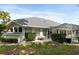 Backyard featuring a screened-in patio, well-kept lawn, and trimmed bushes at 5182 Championship Cup Ln, Spring Hill, FL 34609