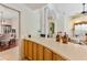 Convenient wet bar with wooden cabinetry, decorative decor, and open views of the dining and living areas at 5182 Championship Cup Ln, Spring Hill, FL 34609