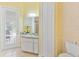Cozy bathroom features a vanity, mirrored wall, access to the patio, and neutral tiling at 5182 Championship Cup Ln, Spring Hill, FL 34609