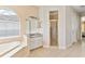 Bright bathroom featuring a soaking tub under a window and a separate shower with glass doors at 5182 Championship Cup Ln, Spring Hill, FL 34609