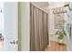 Bathroom with a decorative shower curtain and a tropical houseplant, adding a touch of nature at 5182 Championship Cup Ln, Spring Hill, FL 34609