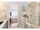 Bright en-suite bathroom featuring a modern glass shower and access to a serene bedroom at 5182 Championship Cup Ln, Spring Hill, FL 34609