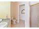 Compact bathroom boasts a walk-in shower, neutral tiling, and a matching vanity at 5182 Championship Cup Ln, Spring Hill, FL 34609