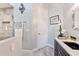 Elegant bathroom boasts a tiled walk-in shower with glass door and granite vanity at 5182 Championship Cup Ln, Spring Hill, FL 34609