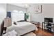 Inviting bedroom featuring large windows, hardwood floors, and a cozy sitting area at 5182 Championship Cup Ln, Spring Hill, FL 34609
