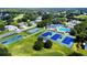 Aerial view of community amenities, including tennis courts, pool, and lush landscaping at 5182 Championship Cup Ln, Spring Hill, FL 34609
