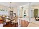 Inviting foyer with hardwood and tile flooring, chandelier, and views of the dining and living areas at 5182 Championship Cup Ln, Spring Hill, FL 34609
