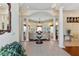 Open-concept foyer with soaring ceilings, decorative columns, and views of the living area with a cozy sitting area at 5182 Championship Cup Ln, Spring Hill, FL 34609