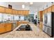 Spacious kitchen with an island cooktop, stainless steel appliances, and open access to living areas at 5182 Championship Cup Ln, Spring Hill, FL 34609