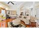 Elegant living room featuring hardwood floors, stately columns, and a curved sofa at 5182 Championship Cup Ln, Spring Hill, FL 34609