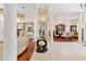 Spacious living area featuring beautiful hardwood flooring, decorative columns, and a formal dining area at 5182 Championship Cup Ln, Spring Hill, FL 34609