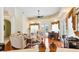 Bright living room with a decorative tray ceiling, hardwood floors, comfortable seating, and access to the pool at 5182 Championship Cup Ln, Spring Hill, FL 34609
