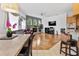 Open-concept living area with fireplace, hardwood floors, and large windows offering natural light at 5182 Championship Cup Ln, Spring Hill, FL 34609