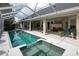 Beautiful screened-in pool and attached hot tub offer relaxation and recreation at 5182 Championship Cup Ln, Spring Hill, FL 34609