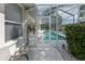 View of screened in pool from the backyard patio at 5182 Championship Cup Ln, Spring Hill, FL 34609