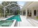 Screened-in pool features a spa and a spacious deck area, ideal for outdoor entertaining at 5182 Championship Cup Ln, Spring Hill, FL 34609