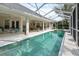Enclosed pool with attached hot tub, and several seating options at 5182 Championship Cup Ln, Spring Hill, FL 34609