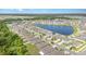 A residential community featuring a scenic pond, well-maintained landscaping, and single-Gathering homes at 5518 Blue Azure Dr, Wimauma, FL 33598