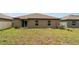 This is a view of the backyard that includes a set of sliding glass doors at 5518 Blue Azure Dr, Wimauma, FL 33598