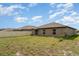 A partial view of the backyard features a sliding glass door and fenced perimeter at 5518 Blue Azure Dr, Wimauma, FL 33598