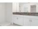 Elegant bathroom featuring a double vanity with granite countertops and a walk-in shower at 5518 Blue Azure Dr, Wimauma, FL 33598