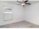 This bedroom offers natural light from the window and includes a ceiling fan for added comfort at 5518 Blue Azure Dr, Wimauma, FL 33598