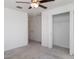 Bright bedroom with a ceiling fan, neutral carpet, closet, and a door to the hallway at 5518 Blue Azure Dr, Wimauma, FL 33598