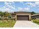 Inviting single story home with manicured landscaping and a two-car garage at 5518 Blue Azure Dr, Wimauma, FL 33598