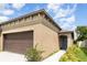 Charming home with a two-car garage, sidewalk, and manicured landscaping at 5518 Blue Azure Dr, Wimauma, FL 33598