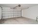 This is an attached two car garage featuring an automatic door at 5518 Blue Azure Dr, Wimauma, FL 33598
