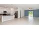 Spacious living room that opens to the kitchen and features modern tile floors at 5518 Blue Azure Dr, Wimauma, FL 33598