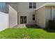 Backyard with green grass, patio, privacy fence, and a sliding glass door at 568 Shoreham Ne Ct, St Petersburg, FL 33716