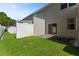Enclosed backyard featuring lush green grass and a concrete patio area provides a cozy outdoor space at 568 Shoreham Ne Ct, St Petersburg, FL 33716