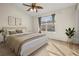 Bright bedroom with a ceiling fan, a large window with curtains, and minimalist décor at 568 Shoreham Ne Ct, St Petersburg, FL 33716