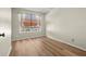 Empty bedroom featuring a window with blinds and curtains, and wood floors at 568 Shoreham Ne Ct, St Petersburg, FL 33716