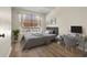 Bedroom featuring wood floors, a window with curtains and blinds, and neutral-toned furniture at 568 Shoreham Ne Ct, St Petersburg, FL 33716