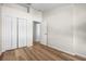 Bedroom featuring wood floors, white walls and trim, and double closets at 568 Shoreham Ne Ct, St Petersburg, FL 33716