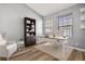 Bright virtual staged office with modern white furniture and wood-look flooring at 568 Shoreham Ne Ct, St Petersburg, FL 33716