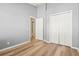 Bedroom featuring wood floors, gray walls and trim, double closets, and open doorway at 568 Shoreham Ne Ct, St Petersburg, FL 33716