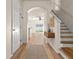 Bright foyer featuring wood-look flooring, staircase, and table at 568 Shoreham Ne Ct, St Petersburg, FL 33716