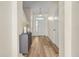 Welcoming entryway with wood flooring, and a modern gray storage table at 568 Shoreham Ne Ct, St Petersburg, FL 33716