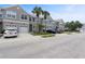 A row of townhomes with well-maintained landscaping and a gray exterior at 568 Shoreham Ne Ct, St Petersburg, FL 33716