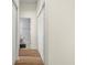 Hallway featuring wood floors, white walls and trim, bathroom, and multiple closets at 568 Shoreham Ne Ct, St Petersburg, FL 33716