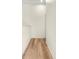 Hallway featuring wood floors, white walls and trim, and doorway at 568 Shoreham Ne Ct, St Petersburg, FL 33716